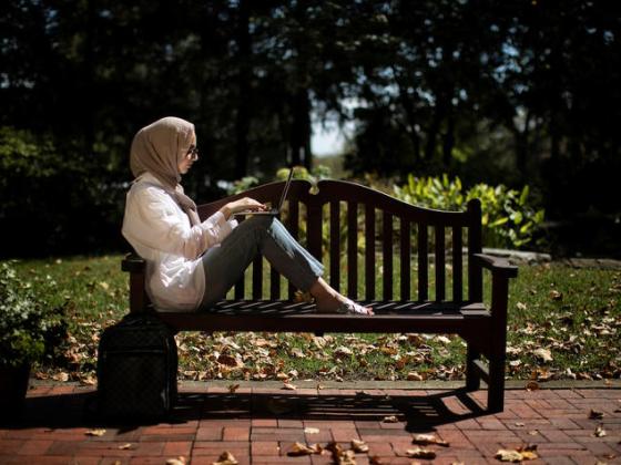 female student sitting on bench