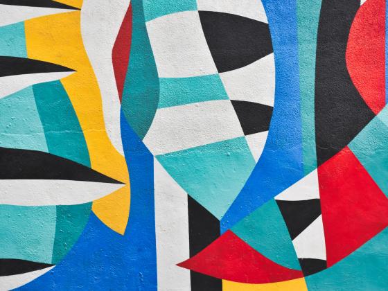 Multi colored abstract image of black and white, yellow, aqua, teal and red shapes
